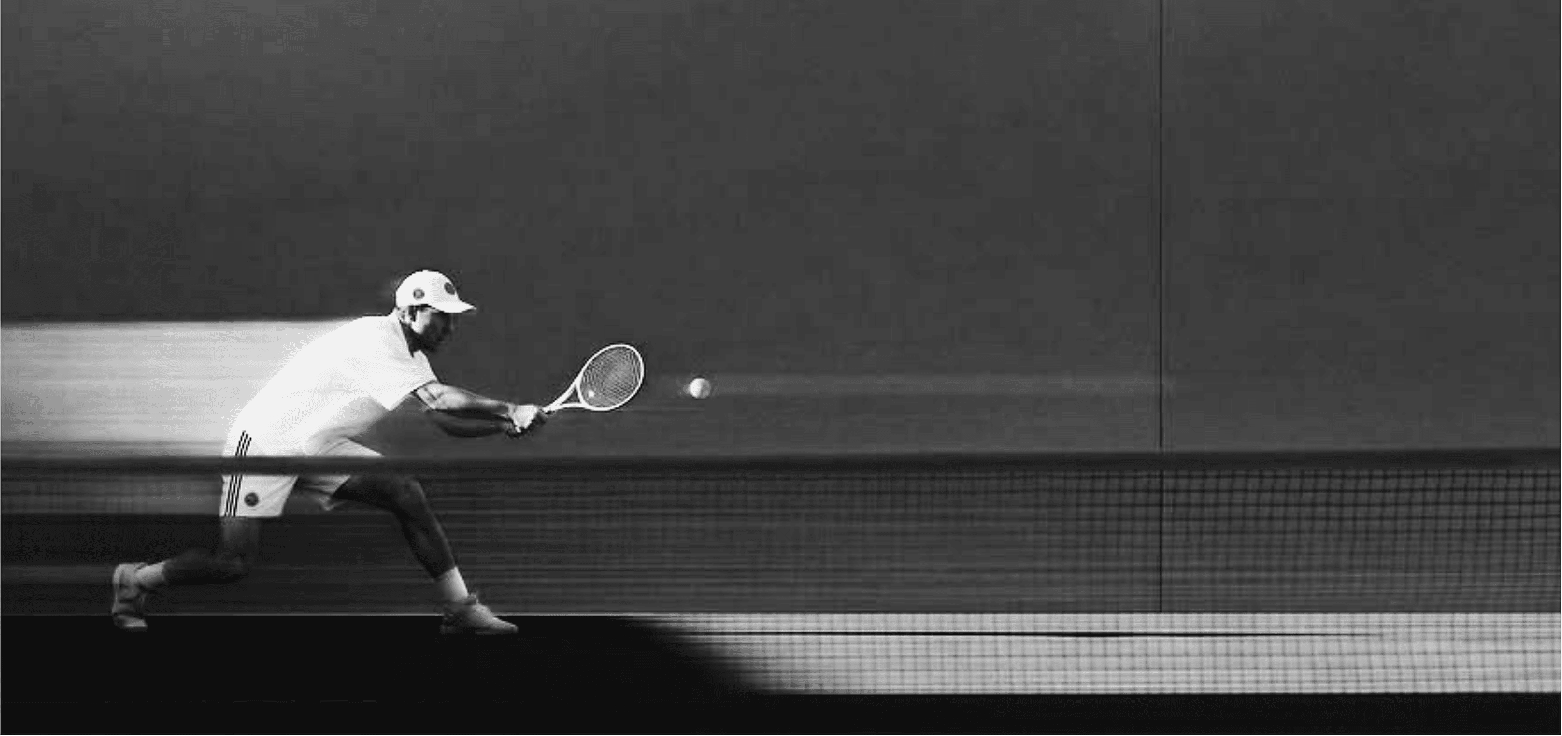 Tennis player reaching for a ball at the net